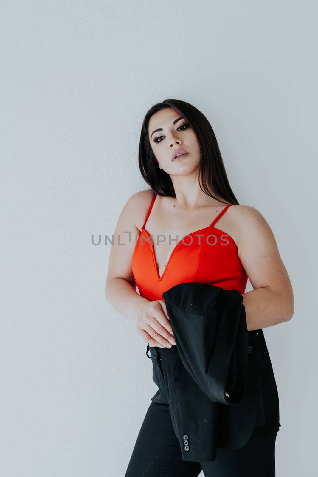 woman holds a jacket in an office space