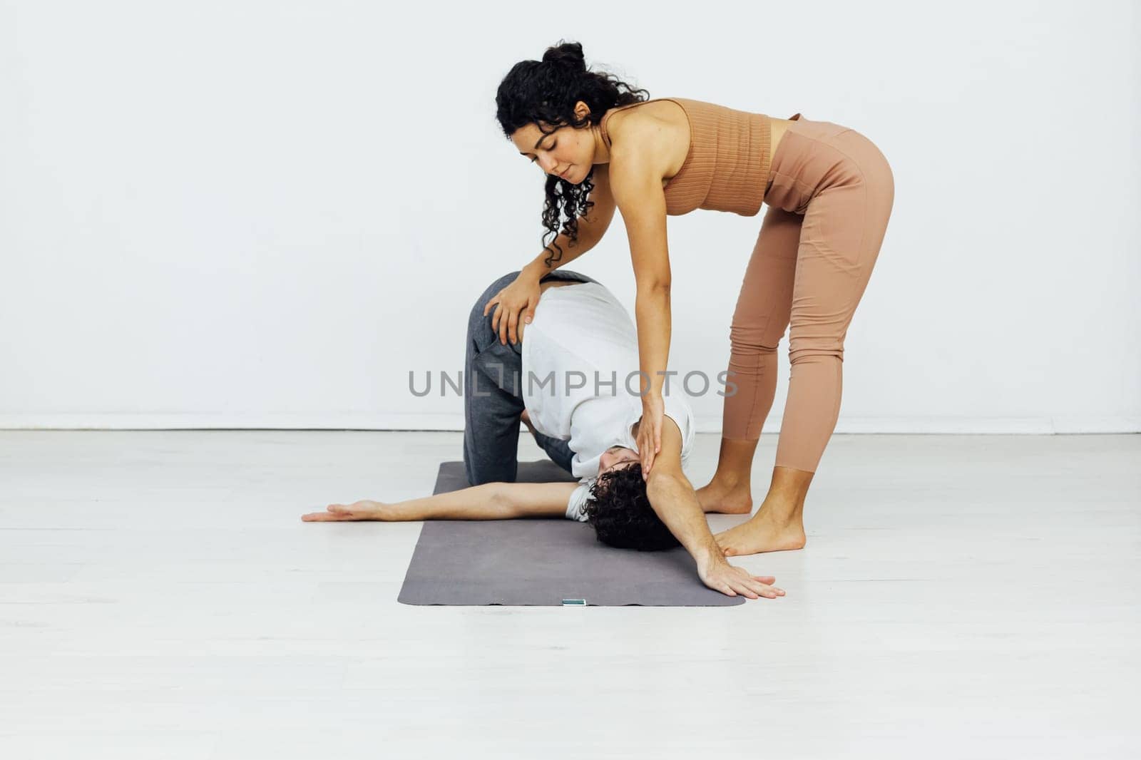 woman stretches vertebrae man workout yoga