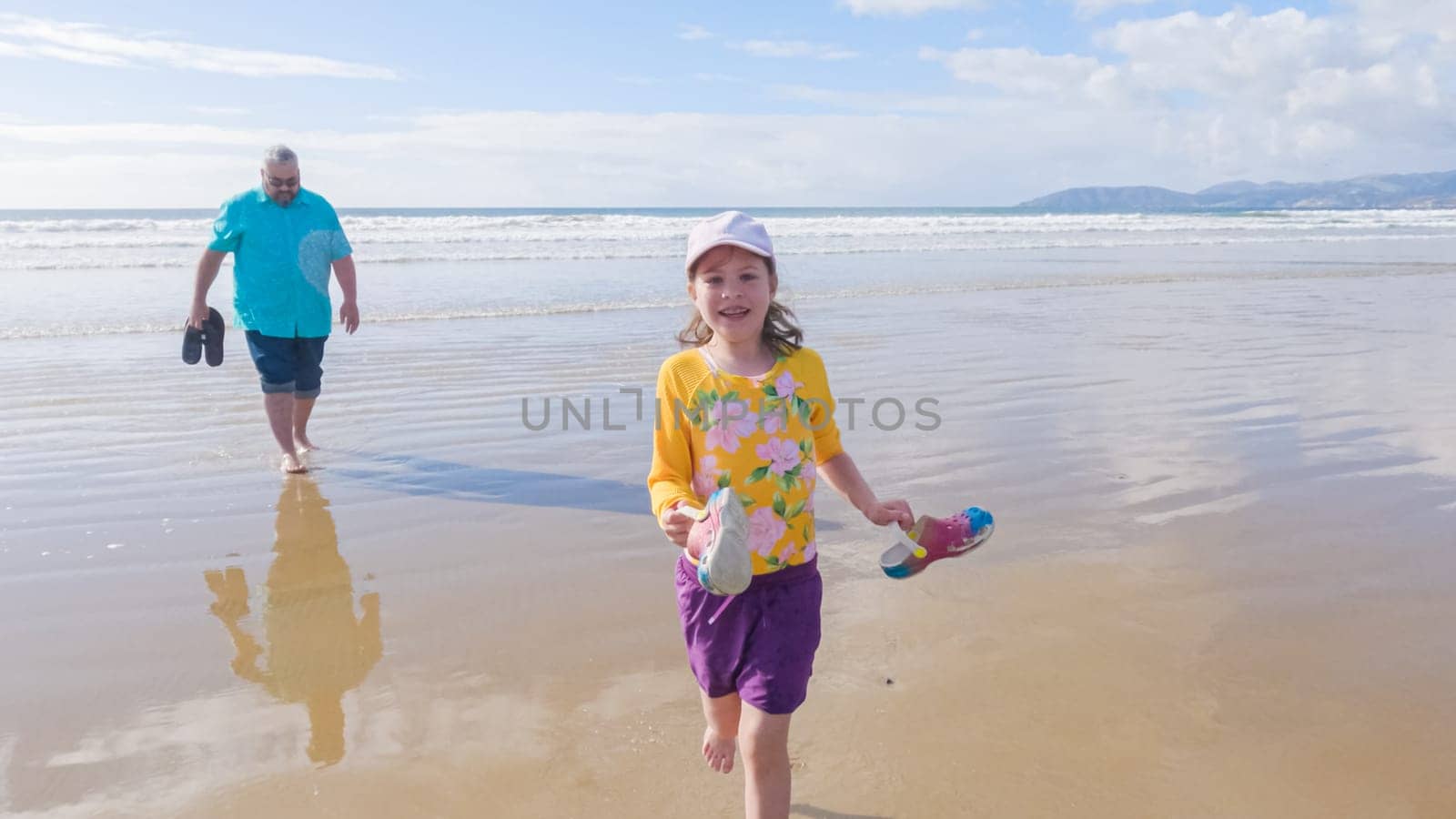 Little Girl Joyfully Running on Winter Beach by arinahabich