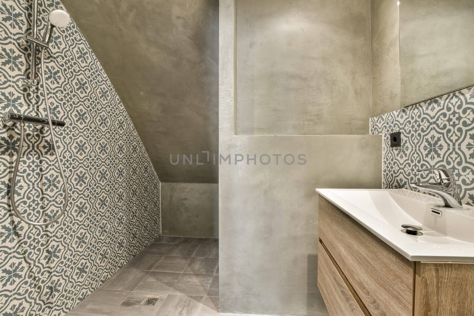 a bathroom with a sink and shower and a mirror by casamedia