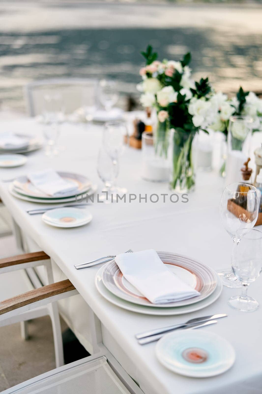 Festively served table with bouquets of flowers by Nadtochiy