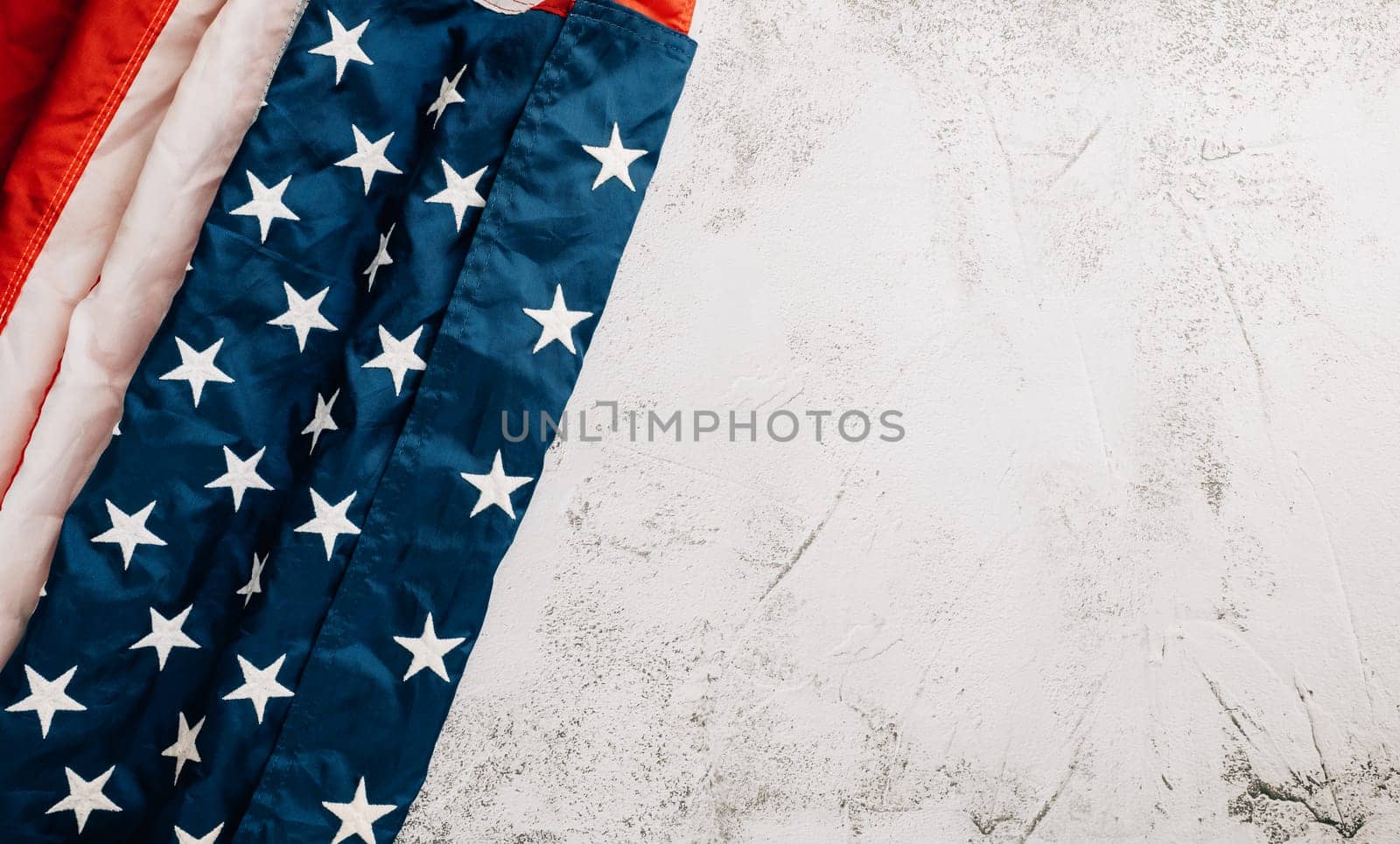 For Veteran's Day, a vintage American flag stands tall, symbolizing honor, unity, and pride in the United States. Patriotic stars and stripes are symbolic. isolated on cement background
