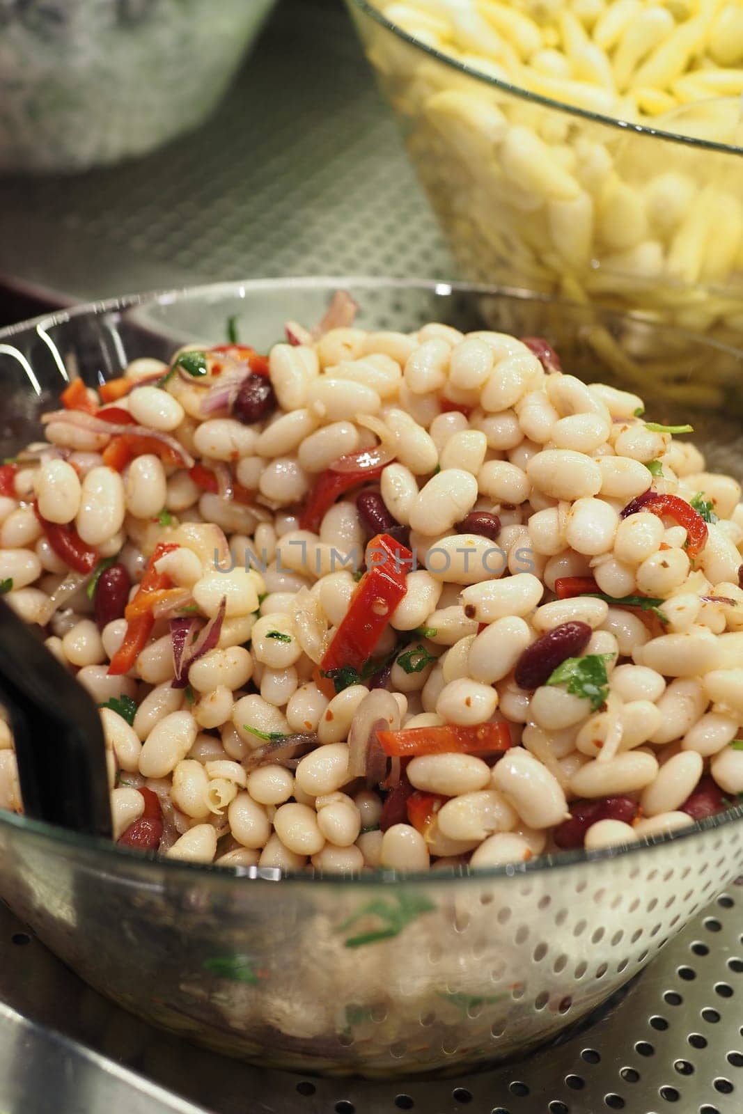 boiled Beans in a bowl served with salad .