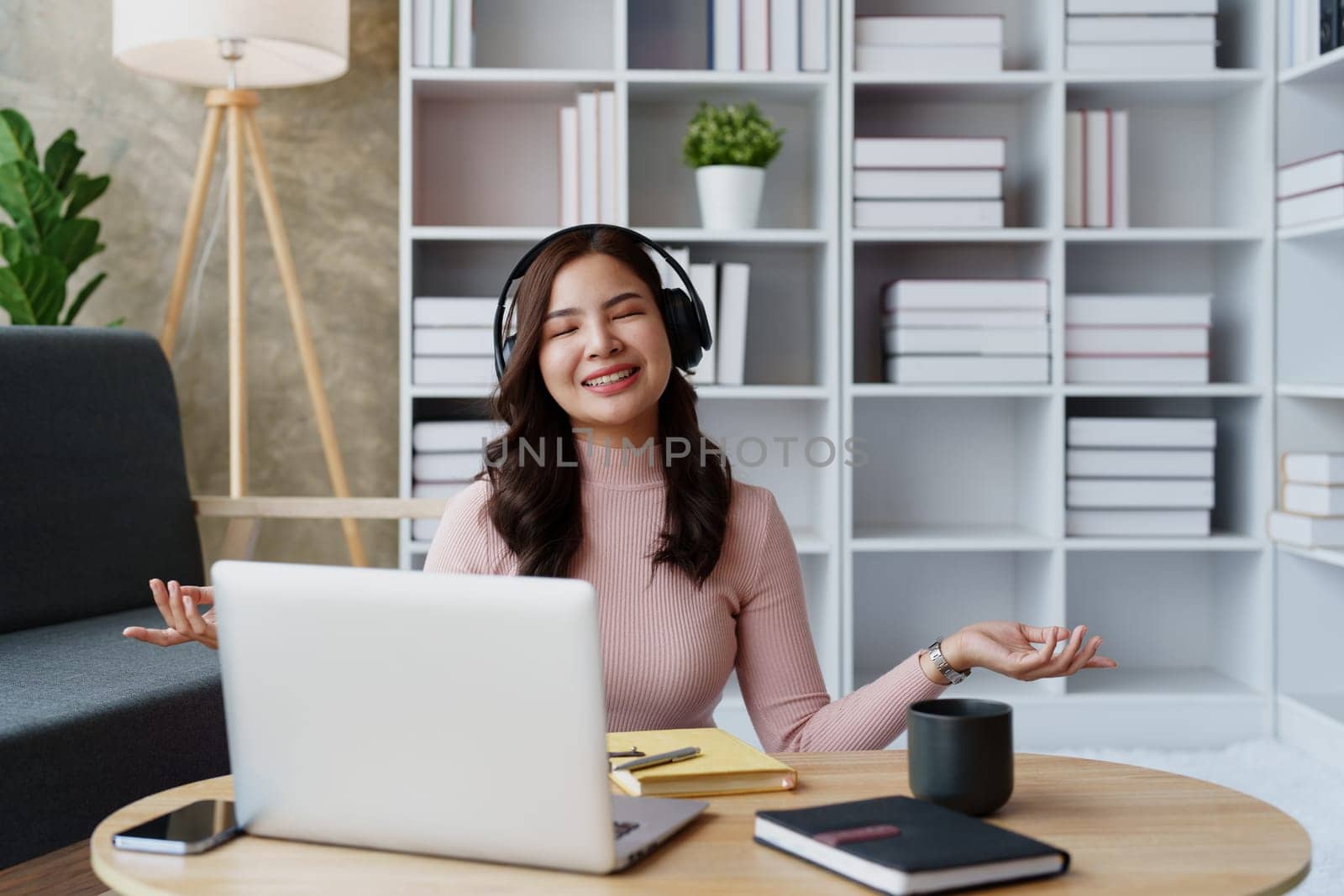 Woman relaxing, wearing headphones and meditating