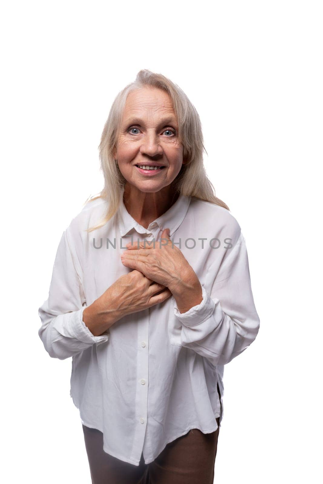 65 year old happy European mature woman wearing shirt on white background.