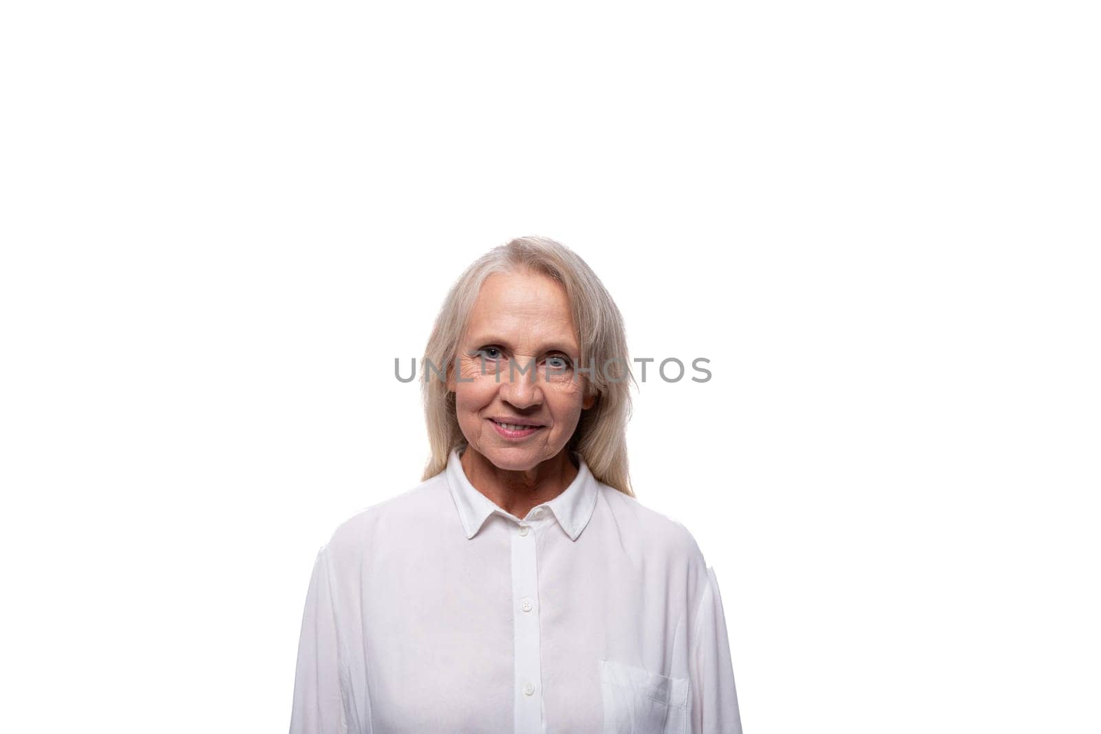 Portrait of an elderly woman with gray hair in a shirt on a white background with copy space.