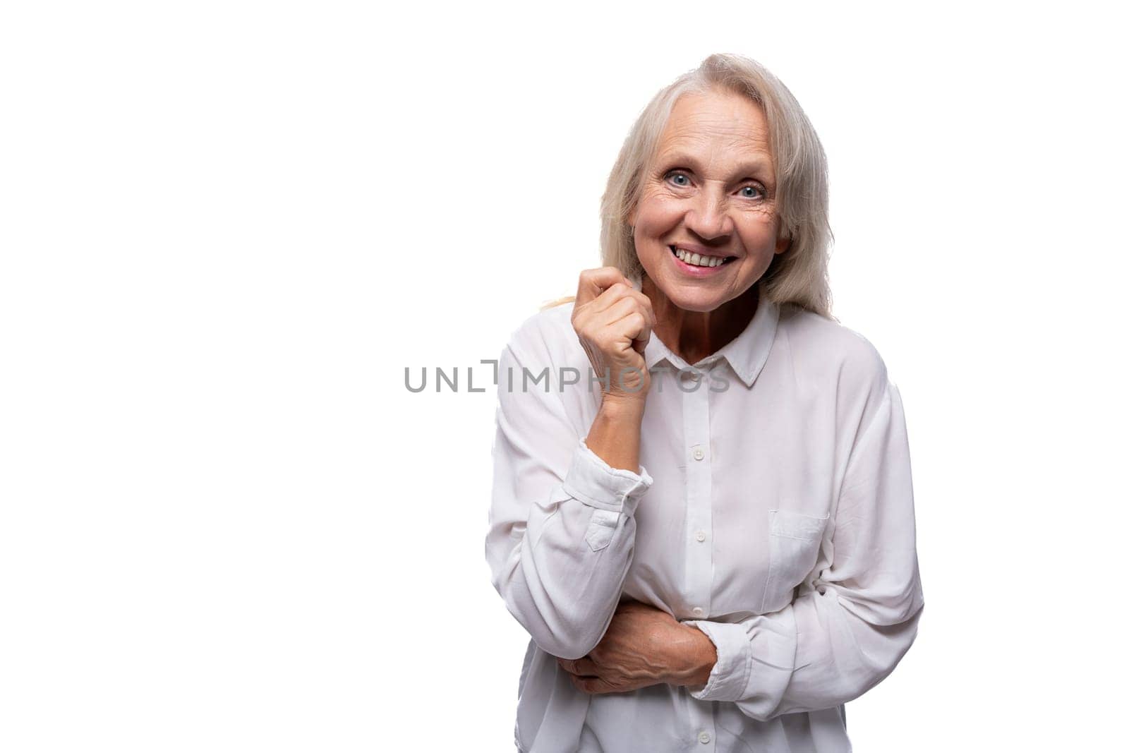 65 year old happy European mature woman wearing shirt on white background.