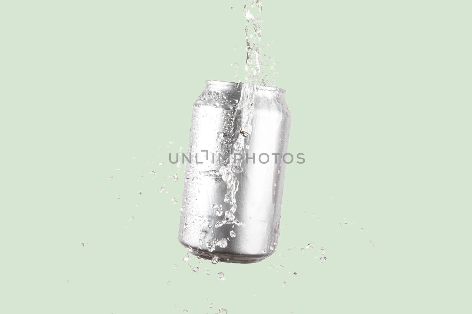 Aluminium beer or soda drinking can with water splash on light green background by TropicalNinjaStudio