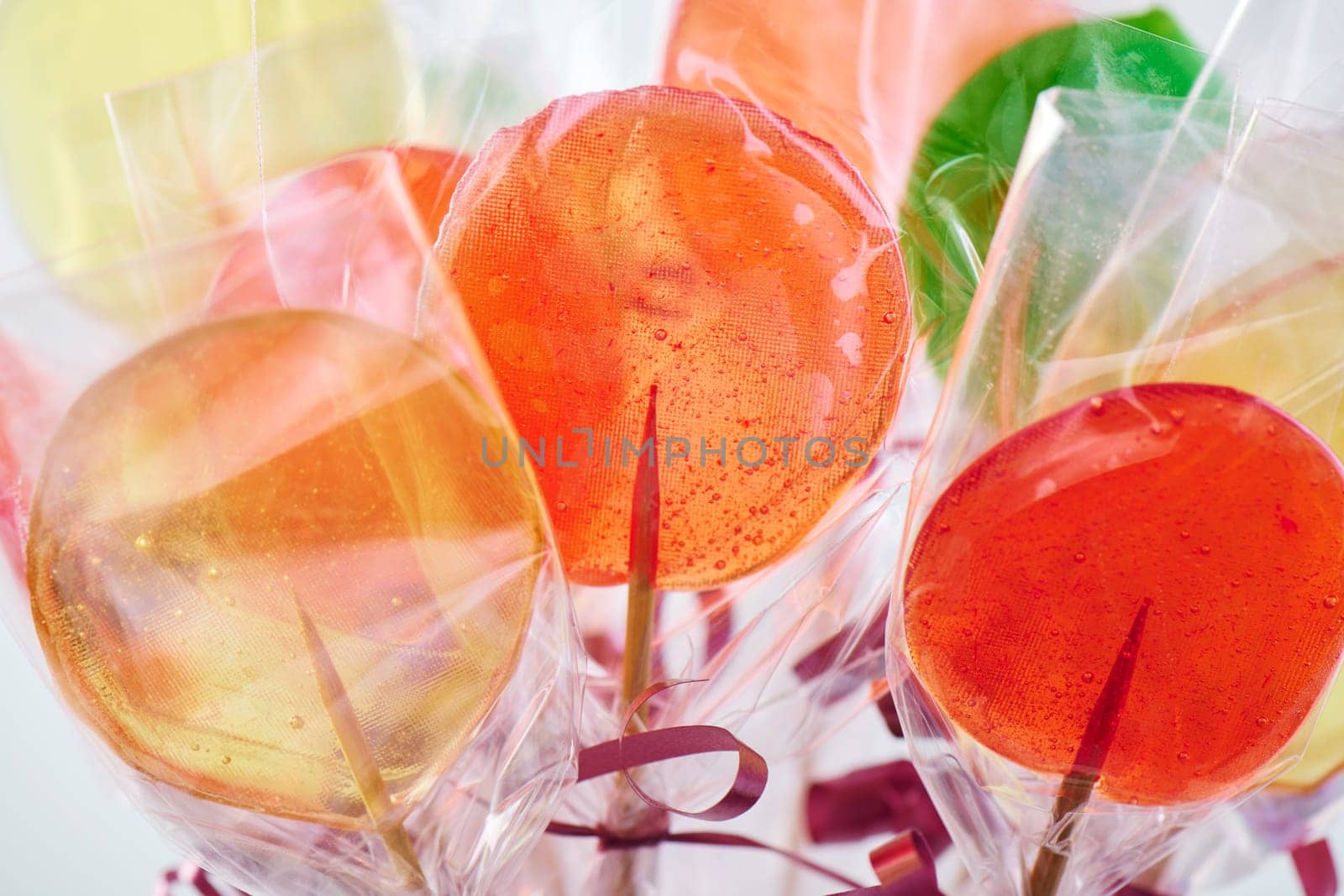 Bunch of several colorful lollipop candies, closeup by maxcab