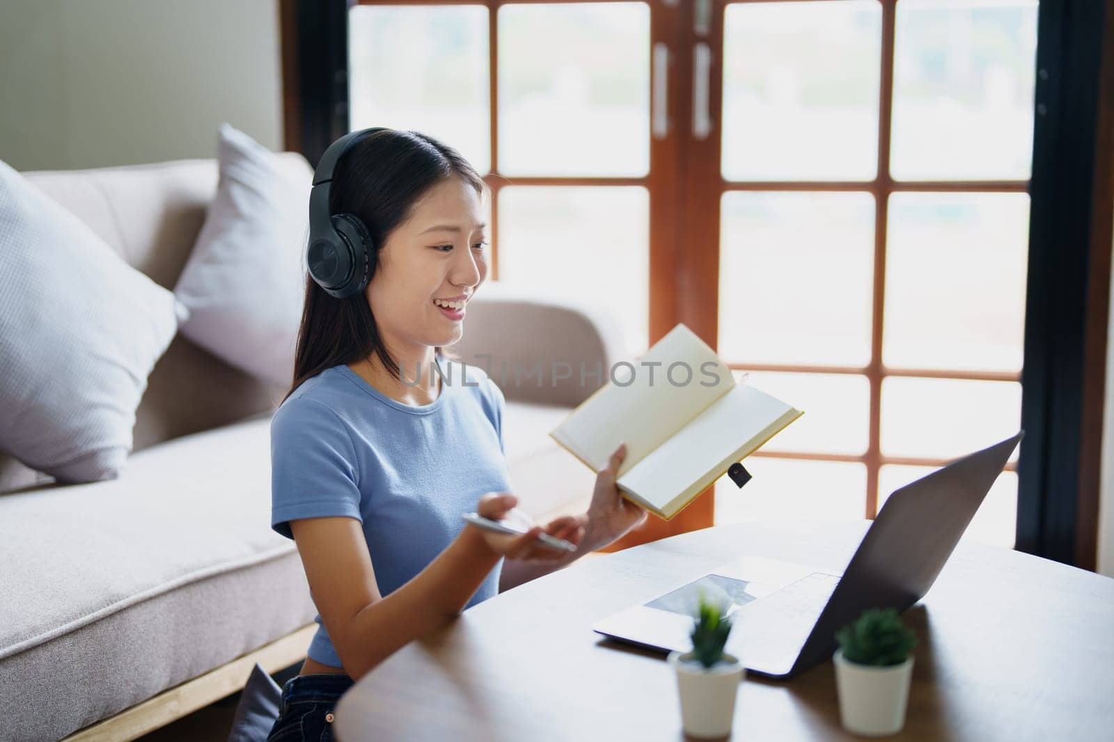 Studying online, beautiful Asian female student or student studying online at home.