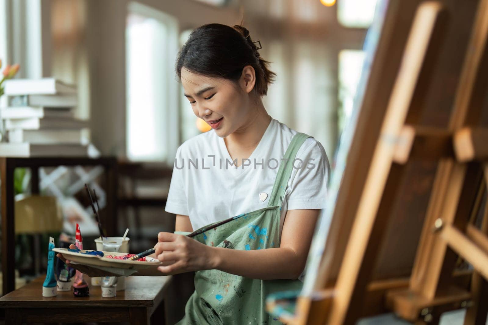 The artist is thinking about his painting with brush painting picture art, creativity, artistic and artwork, painting, Colorful artist brush and paint palette concept.
