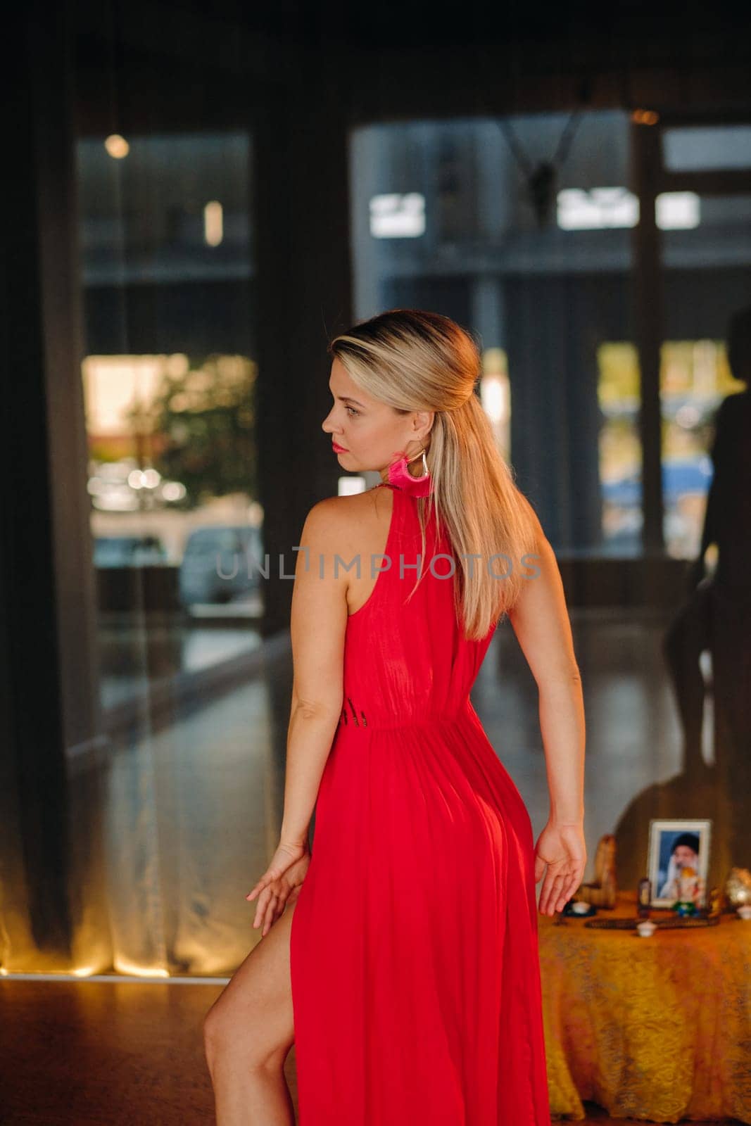 A girl in a red dress moves in a dance meditating indoors . Dynamic dance by Lobachad