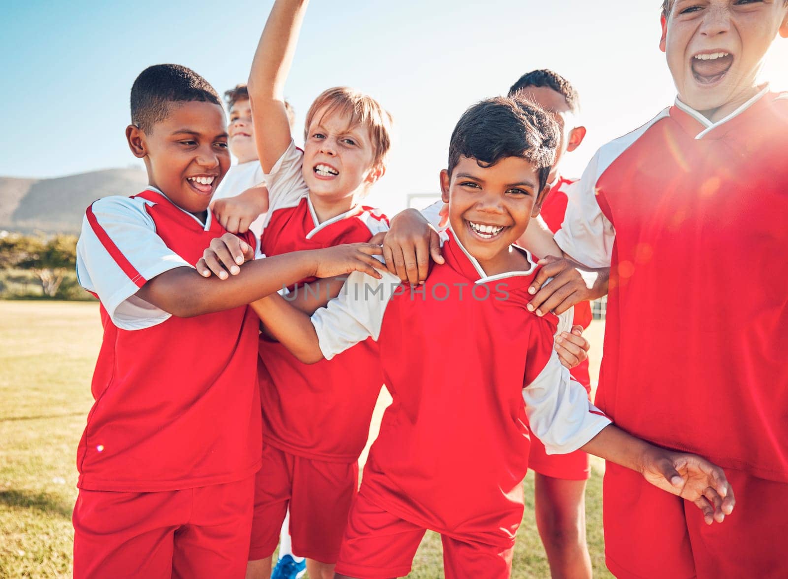 Winner, fitness or happy football children for success, goal or celebration for team building on soccer field. Friends kids or sports children for victory, teamwork or motivation exercise workout.