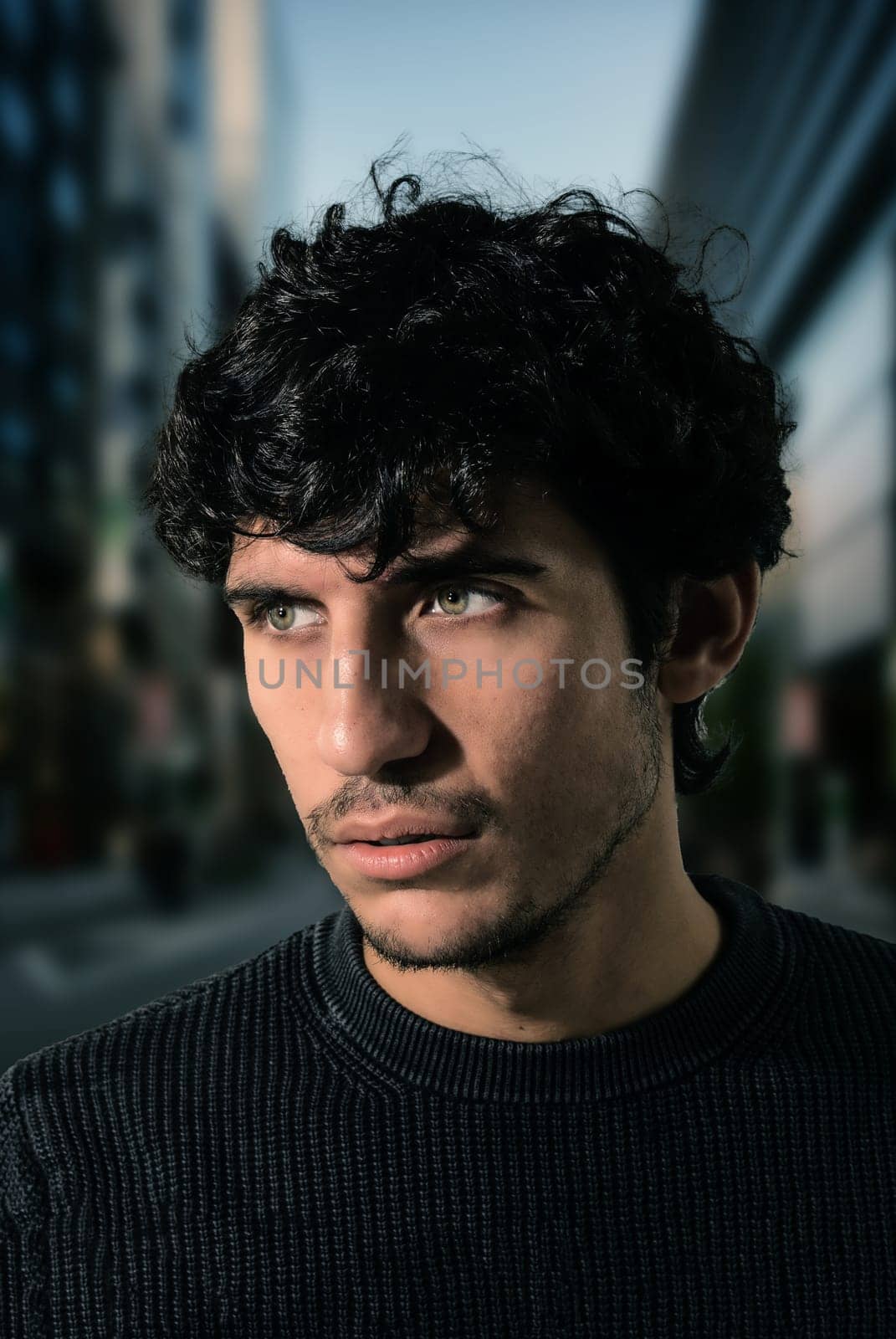 A Curly-Haired Man Standing Tall in the Vibrant Urban Jungle by artofphoto