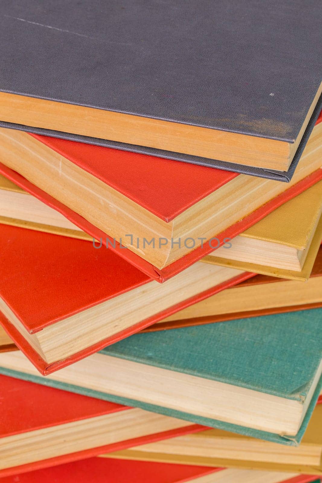 abstract books background - old red and muted green ones in a vertical stack.