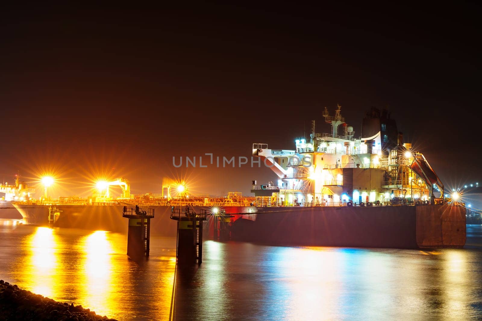Misty Night View of Rotterdam Port Illuminated by City Lights by PhotoTime