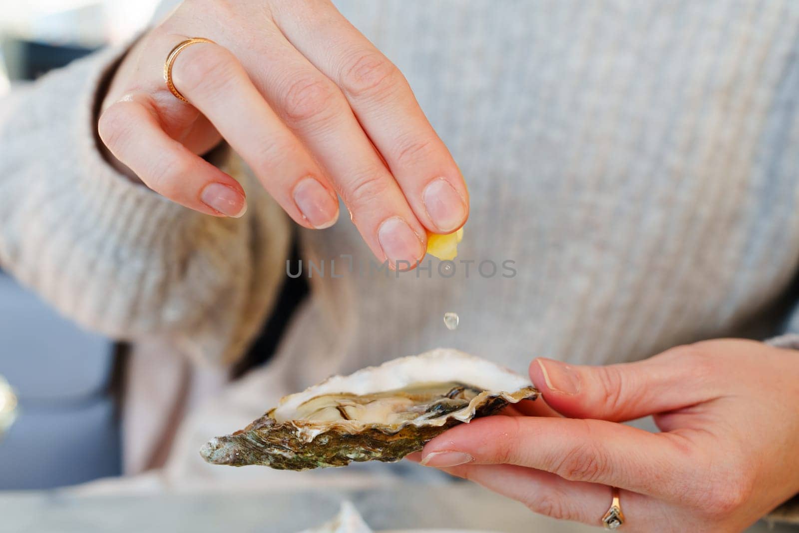 A young girl indulging in a luxurious outdoor picnic, meticulously arranged oysters and lemons served on a plate with fine dining cutlery