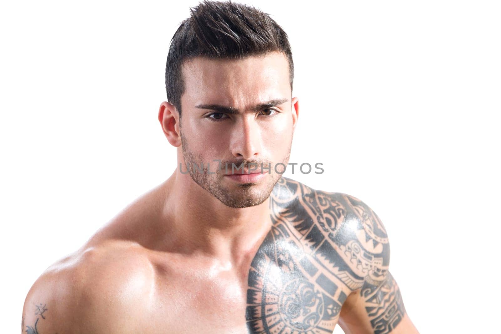Photo of a muscular and handsome man showing off his arm tattoo by artofphoto