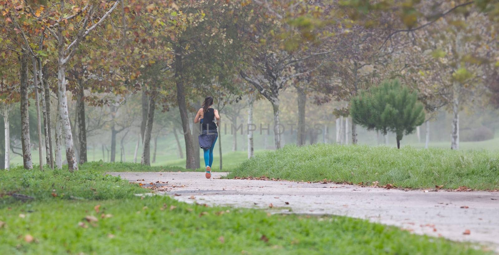 Sportive woman running in park