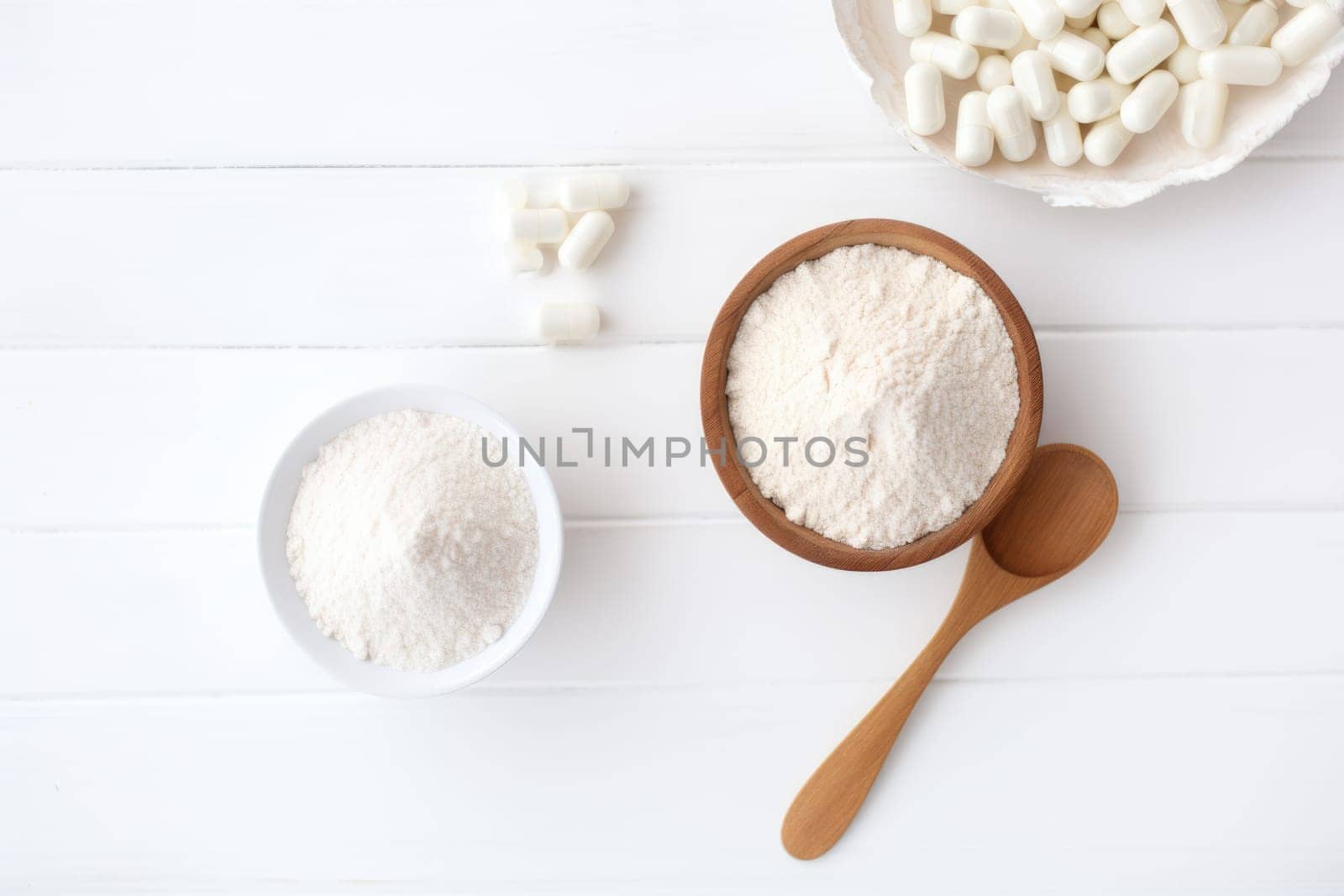 Collagen powder and pills on white background. Top view. AI Generated by Desperada