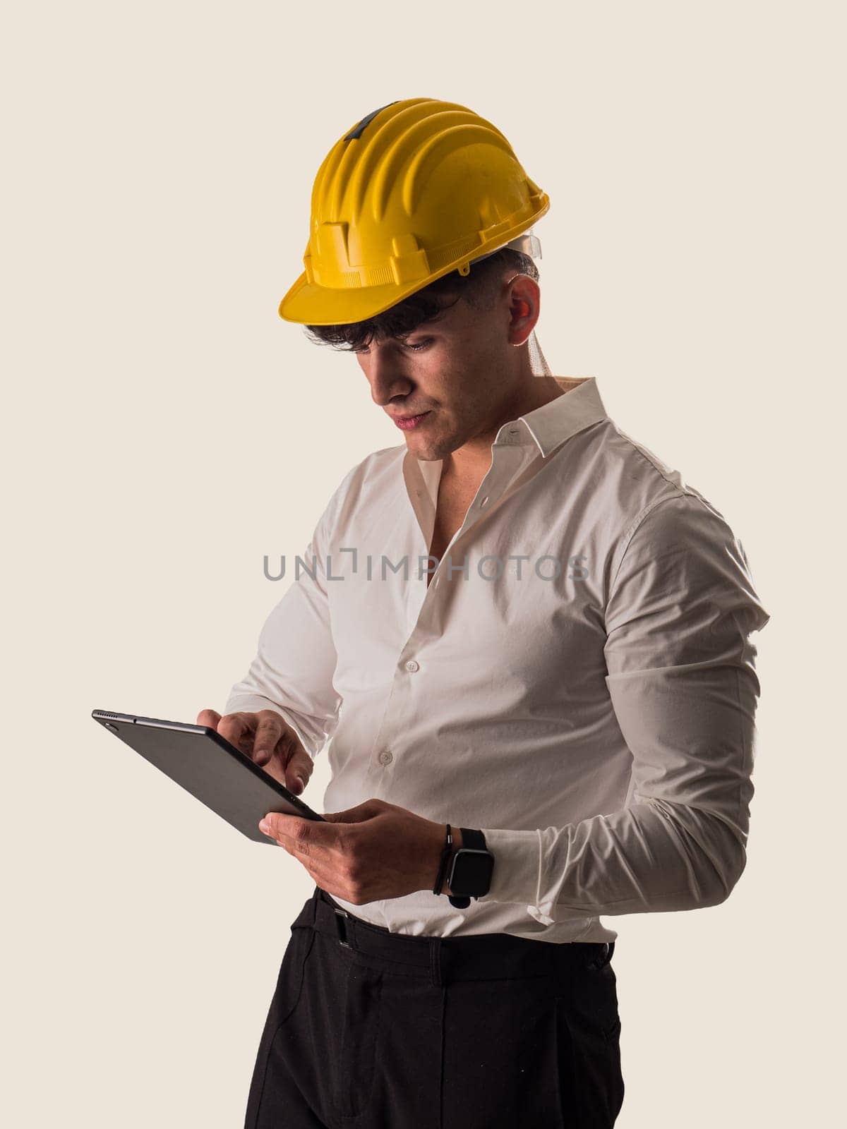 A man in a hard hat holding a tablet