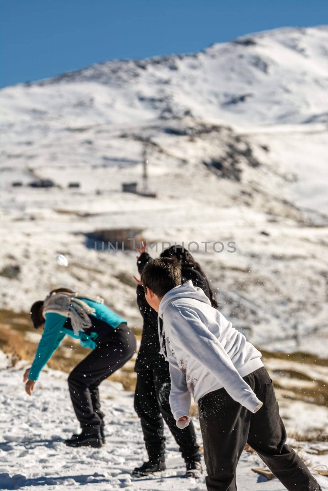 latin family playing in the snow, ski resort, in grenada sierra nevada,