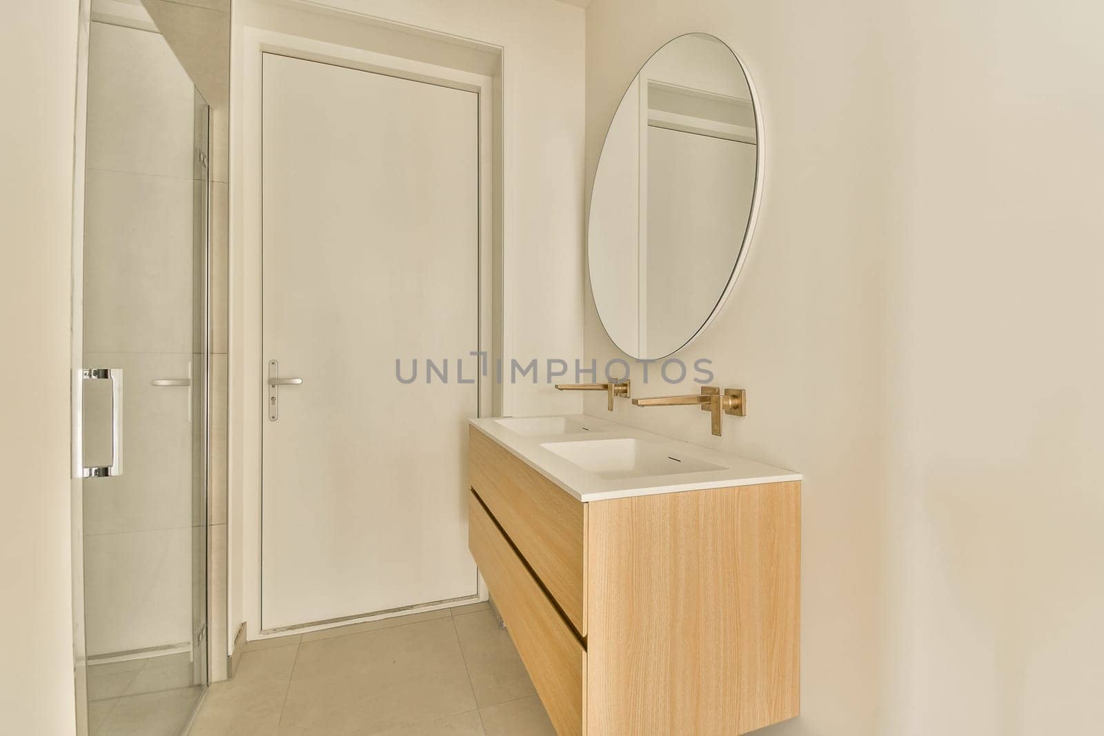 a modern bathroom with a sink and a mirror by casamedia