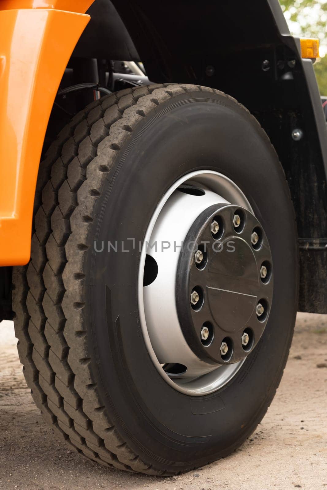 a large wheel with a truck tire. Tire fitting concept by Lobachad