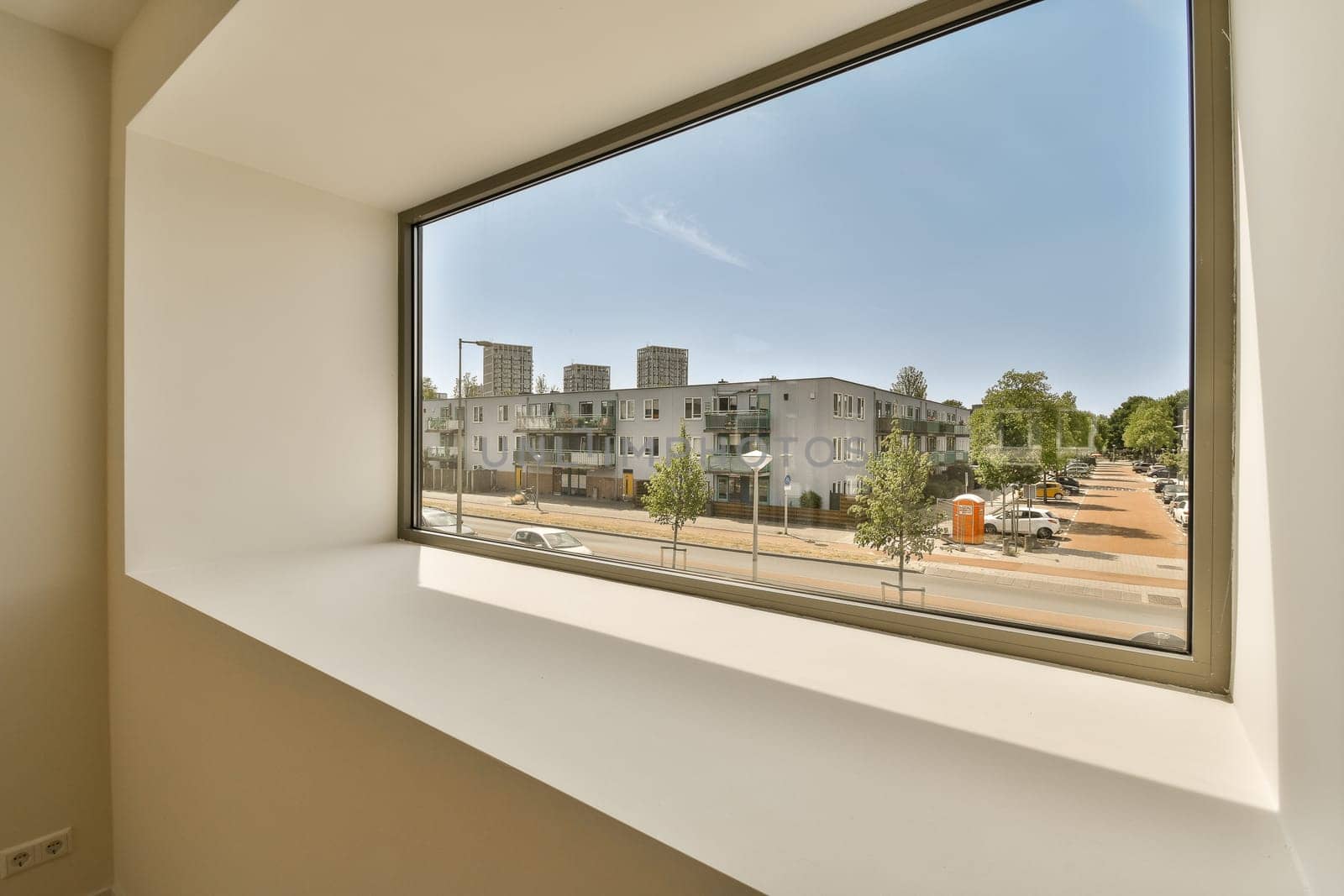 a large window with a view of a city street by casamedia