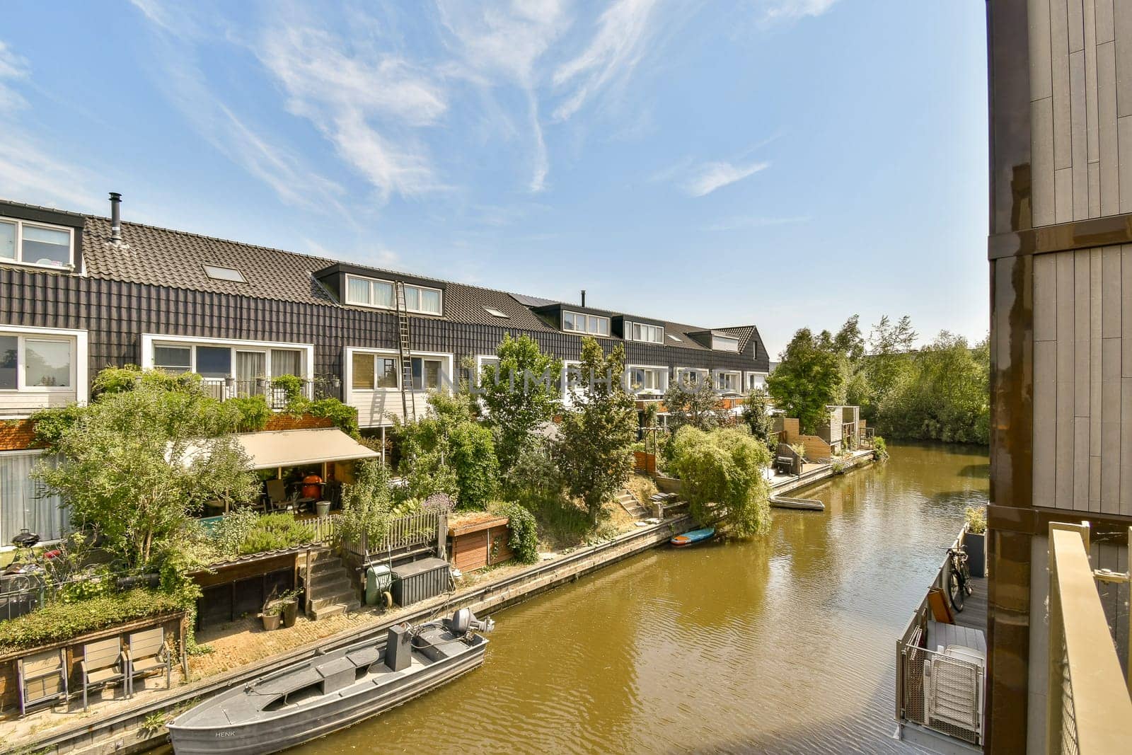 a canal with houses and boats on it by casamedia