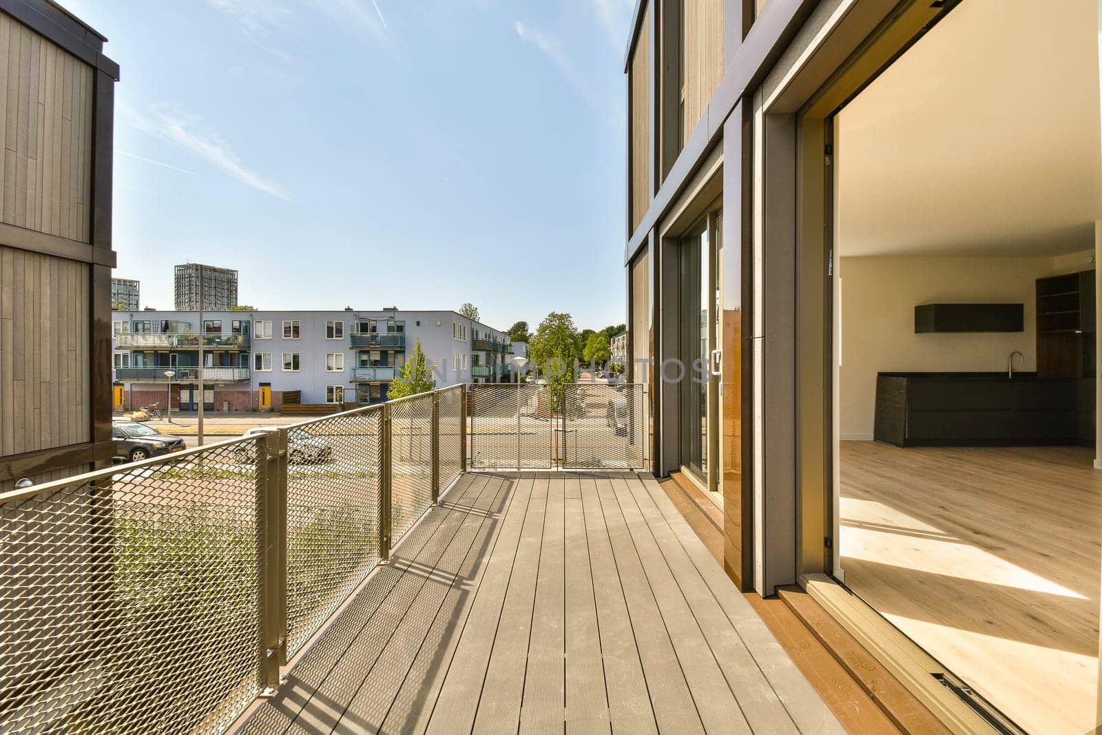a deck with a fence and buildings in the background by casamedia