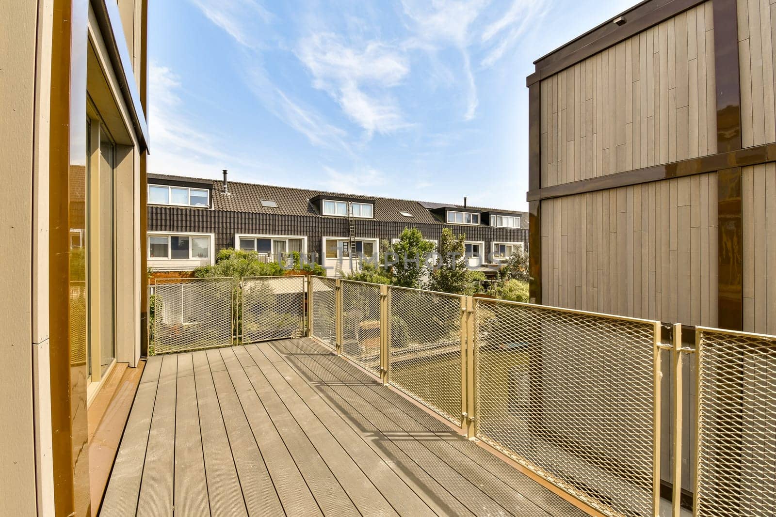 a balcony with a wooden deck and a fence by casamedia