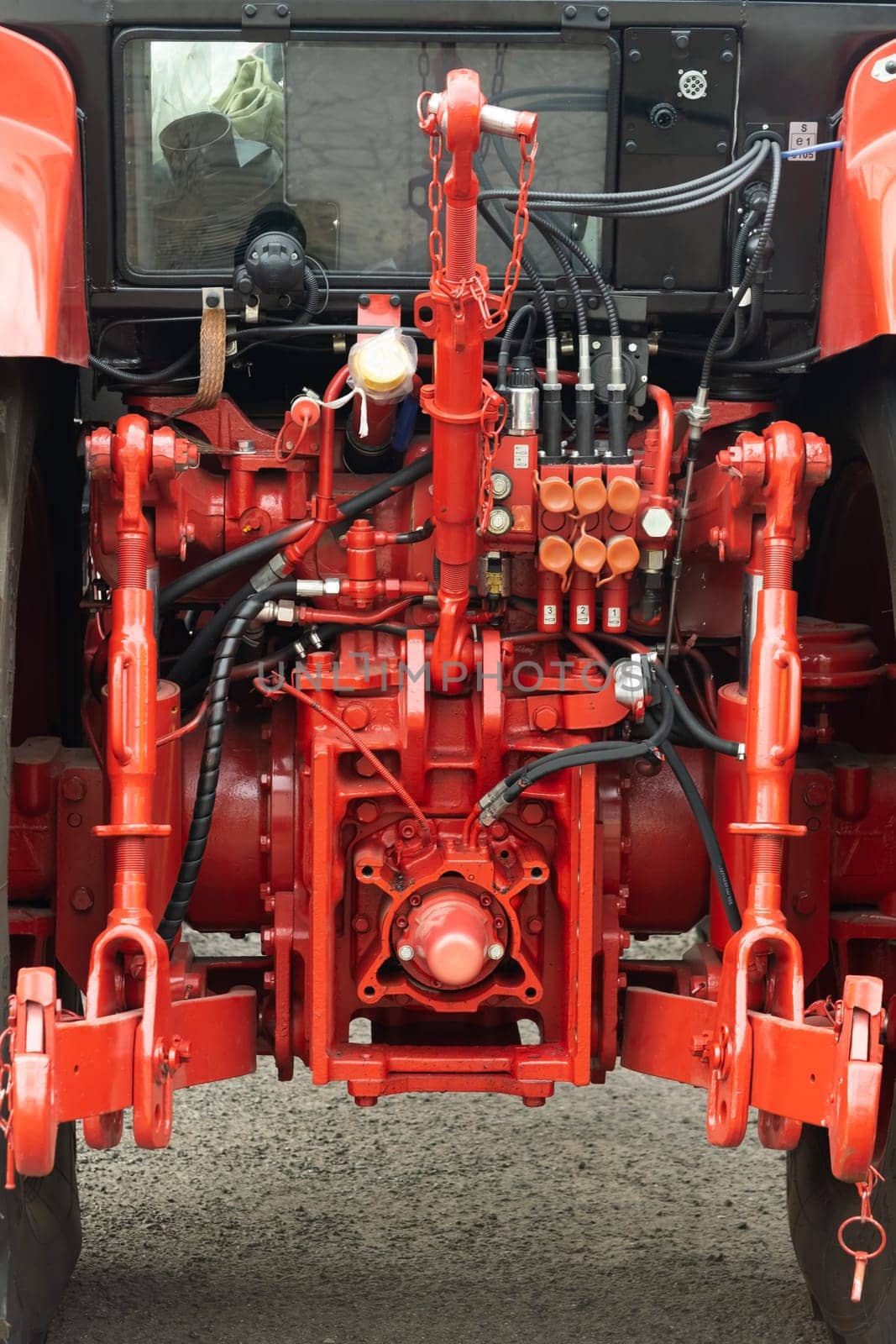 Close-up of part of the new red tractor. Vehicle assembly.