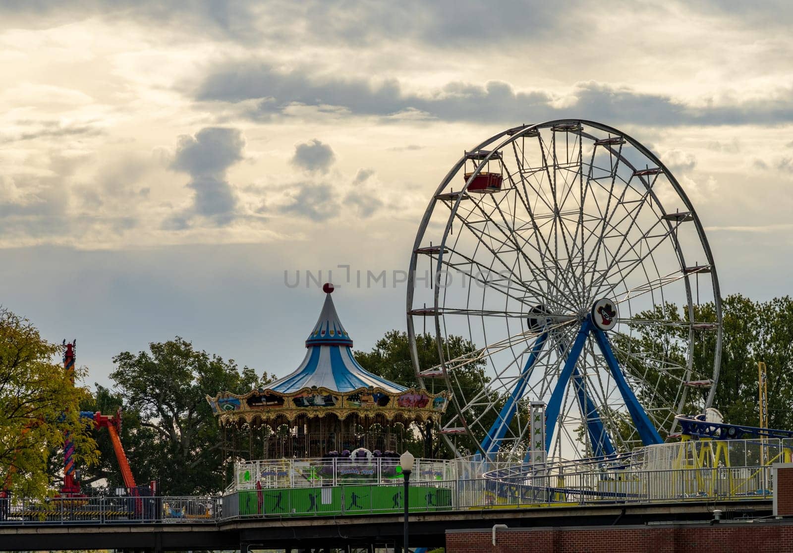 Davenport, IA - 18 October 2023: Dismantling fairground rides in amusement park for winter
