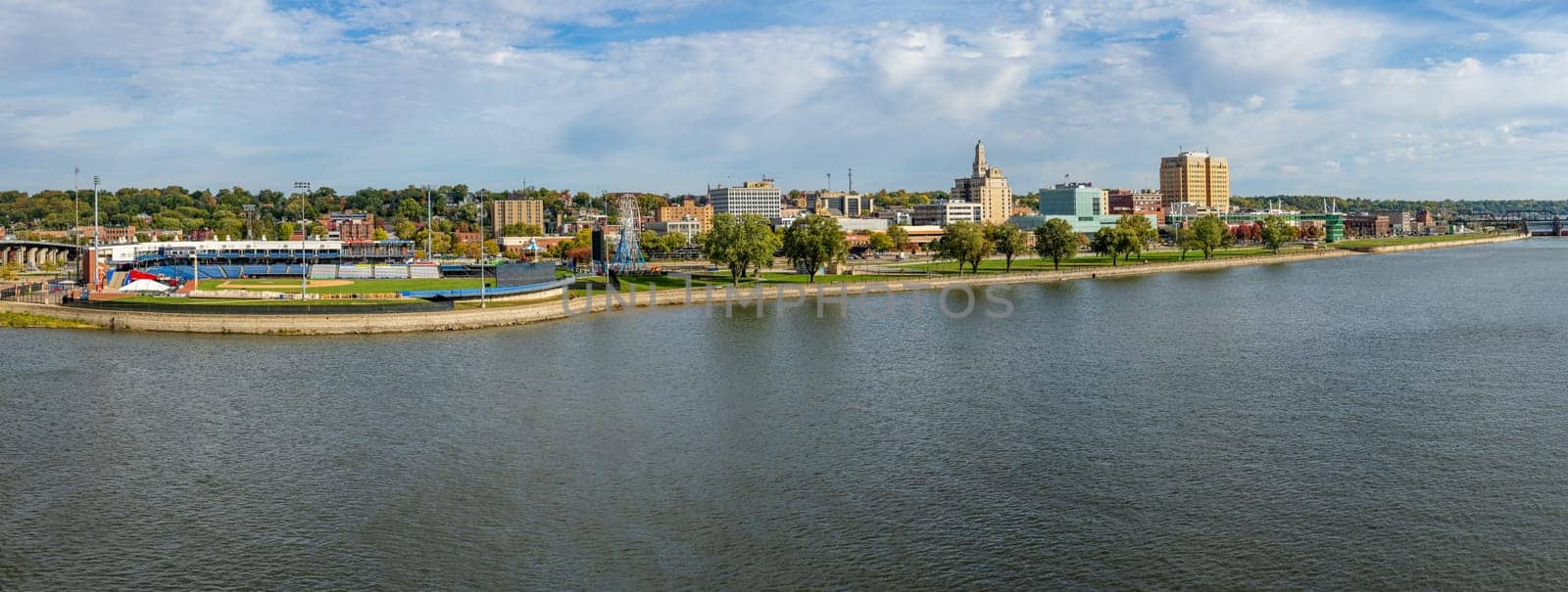 Davenport, IA - 18 October 2023: Panorama of Modern Woodmen Park stadium with downtown Davenport along Mississippi River in Iowa