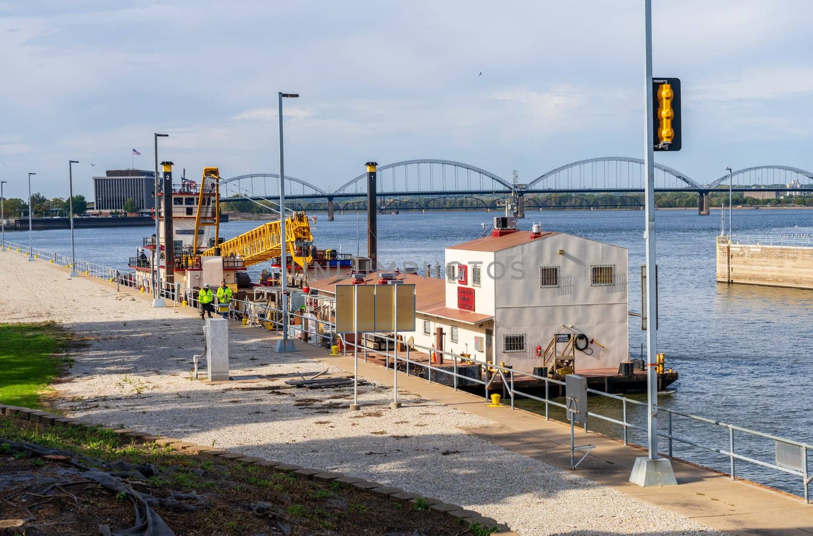 Davenport, IA - 18 October 2023: Army Corps of Engineers barge and crane enters Lock and Dam No. 15 in Davenport, Iowa