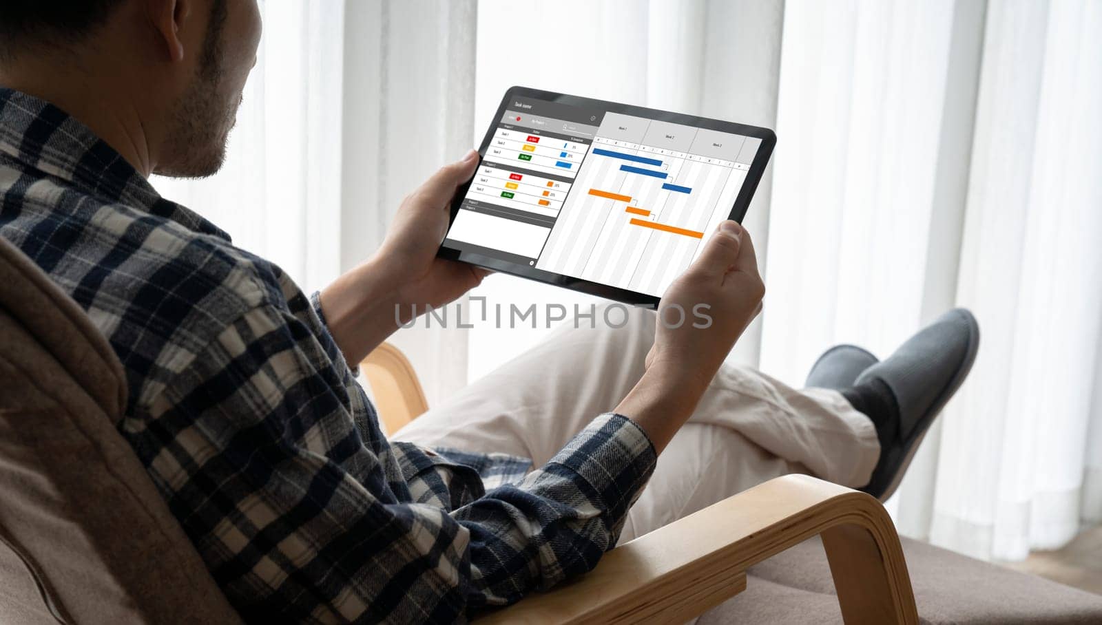 Project planning software for modish business project management on the computer screen showing timeline chart of the team project