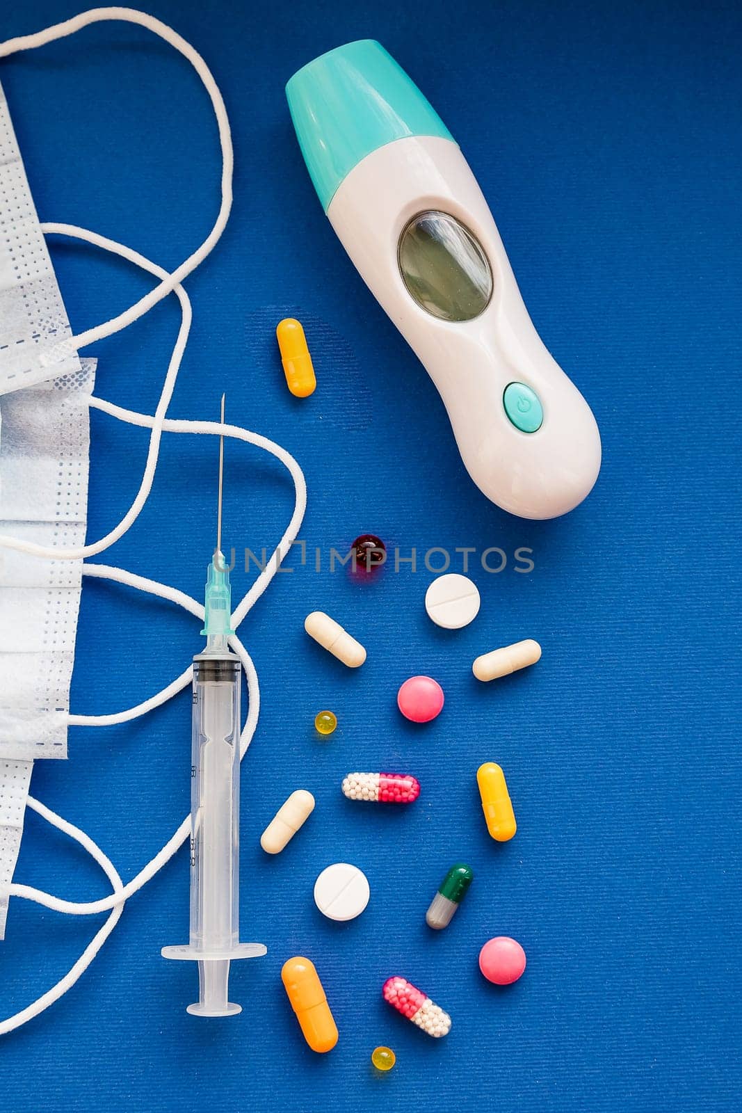 medicine next to a syringe. Medicines for the virus and flu. Medical pills and antibiotics. Coronavirus.