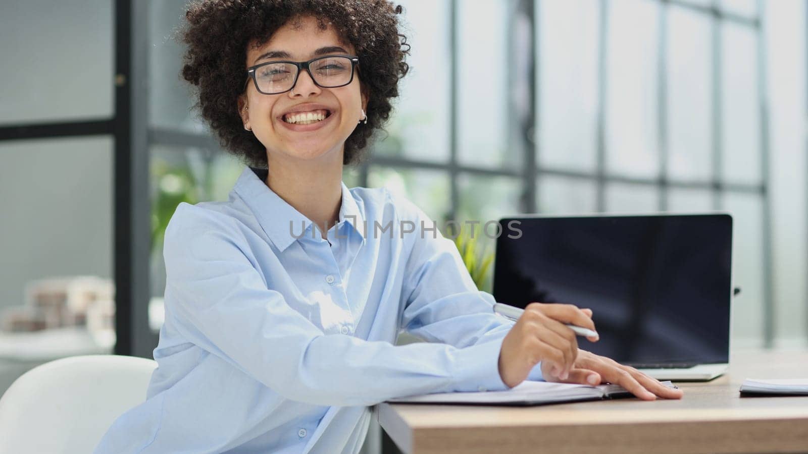 girl in the office smiles expresses success and leadership is thinking about success.