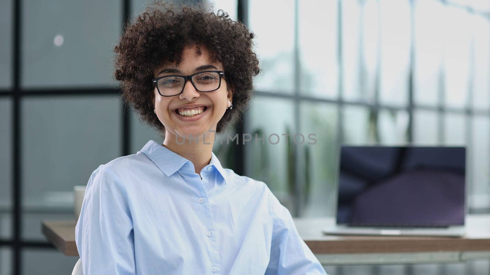 girl in the office smiles expresses success and leadership is thinking about success by Prosto