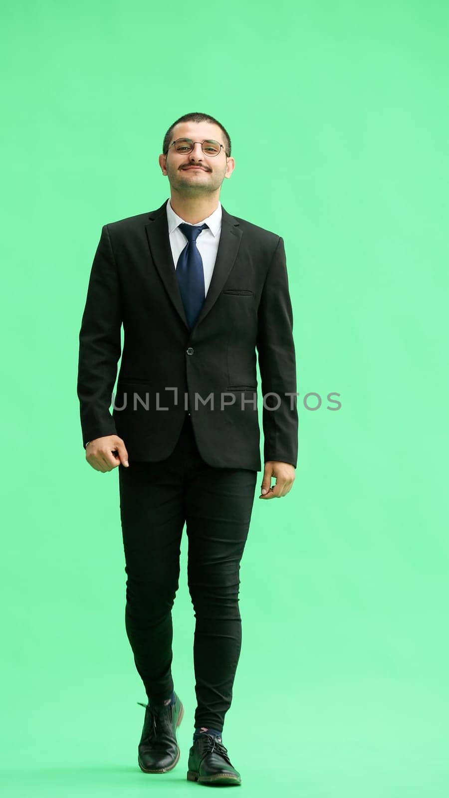 young man in full growth. isolated on green background goes by Prosto