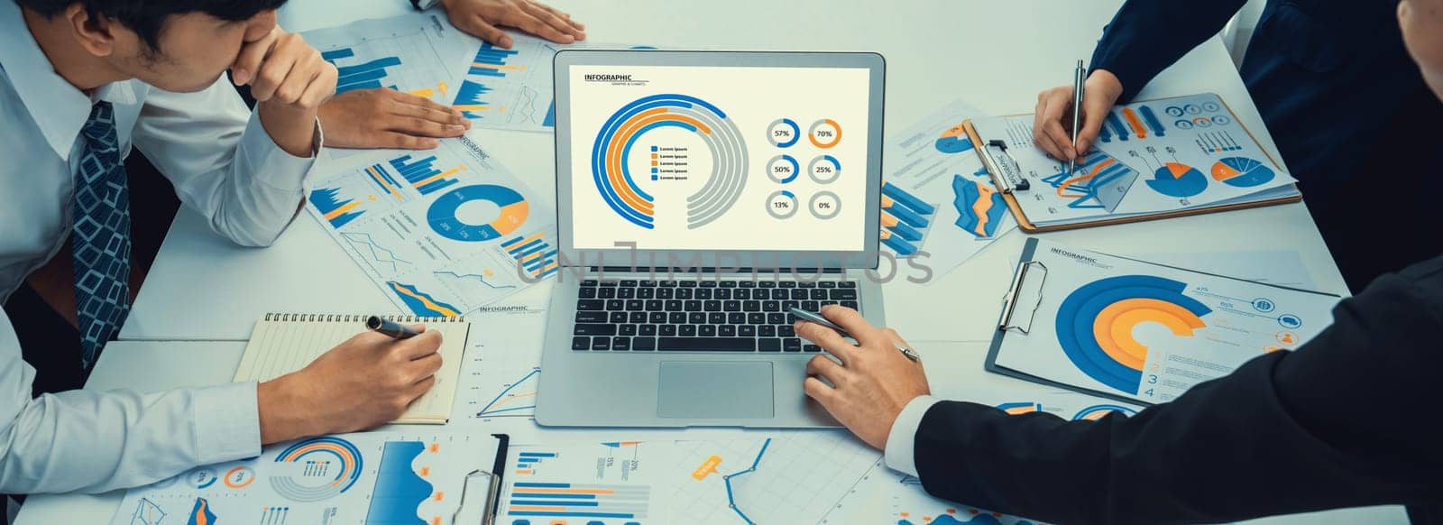 Business people in group meeting in formal attire share idea discussing report for company profit in creative workspace for start up business shot in close up view on group meeting table . Oratory .