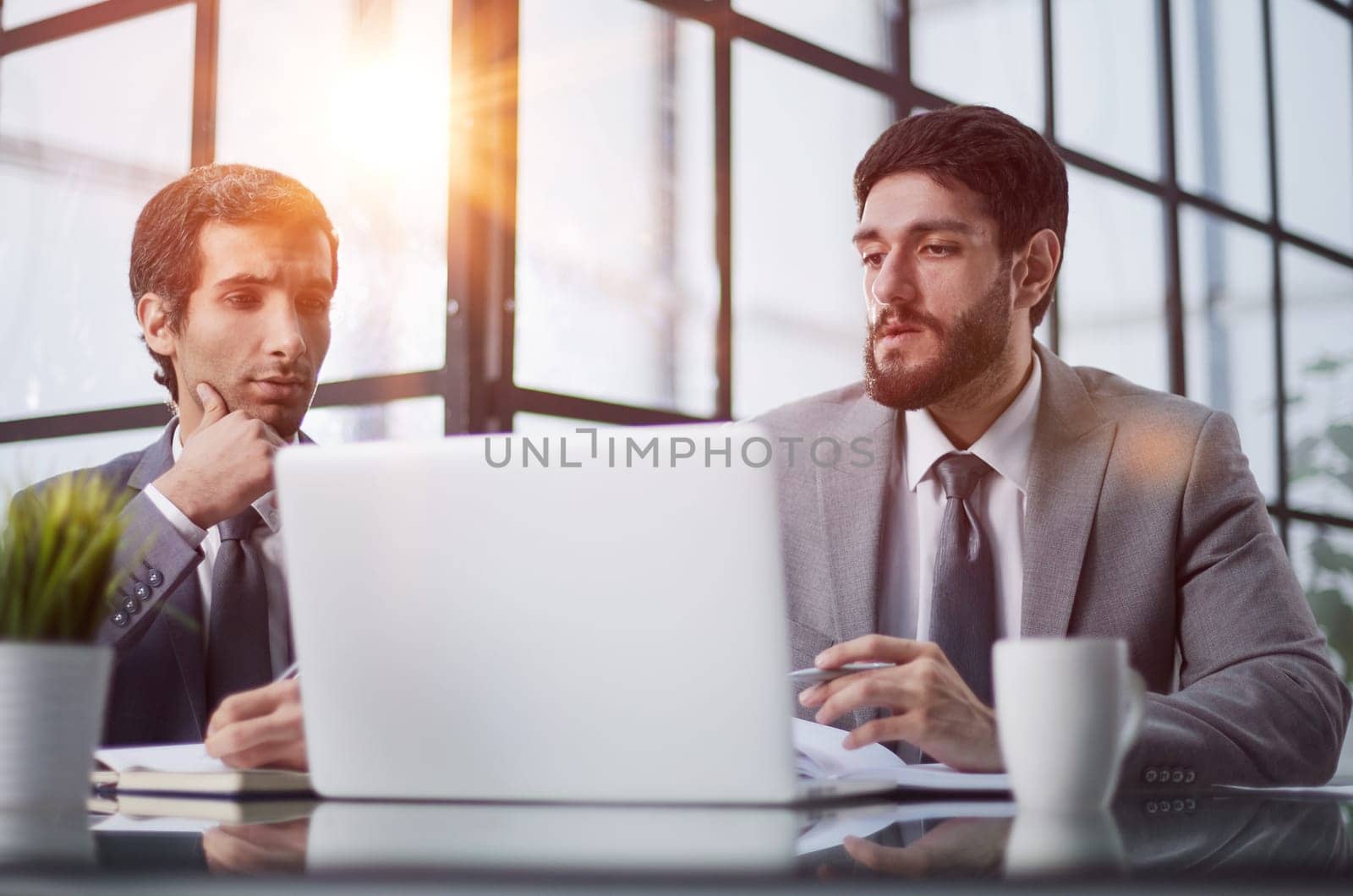 men sitting at a table in a coworking space