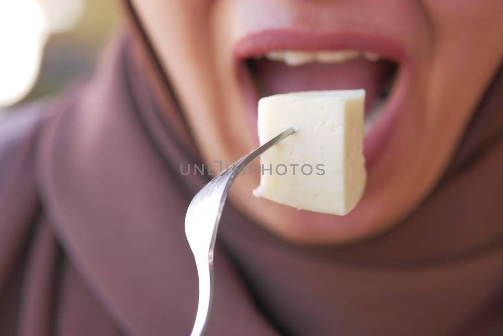 women eating Cheese cubes closeup by towfiq007
