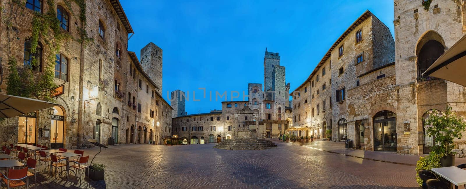 Panoramic view of famous Piazza della Cisterna in the historic town of San Gimignano on a morning, Tuscany, Italy.