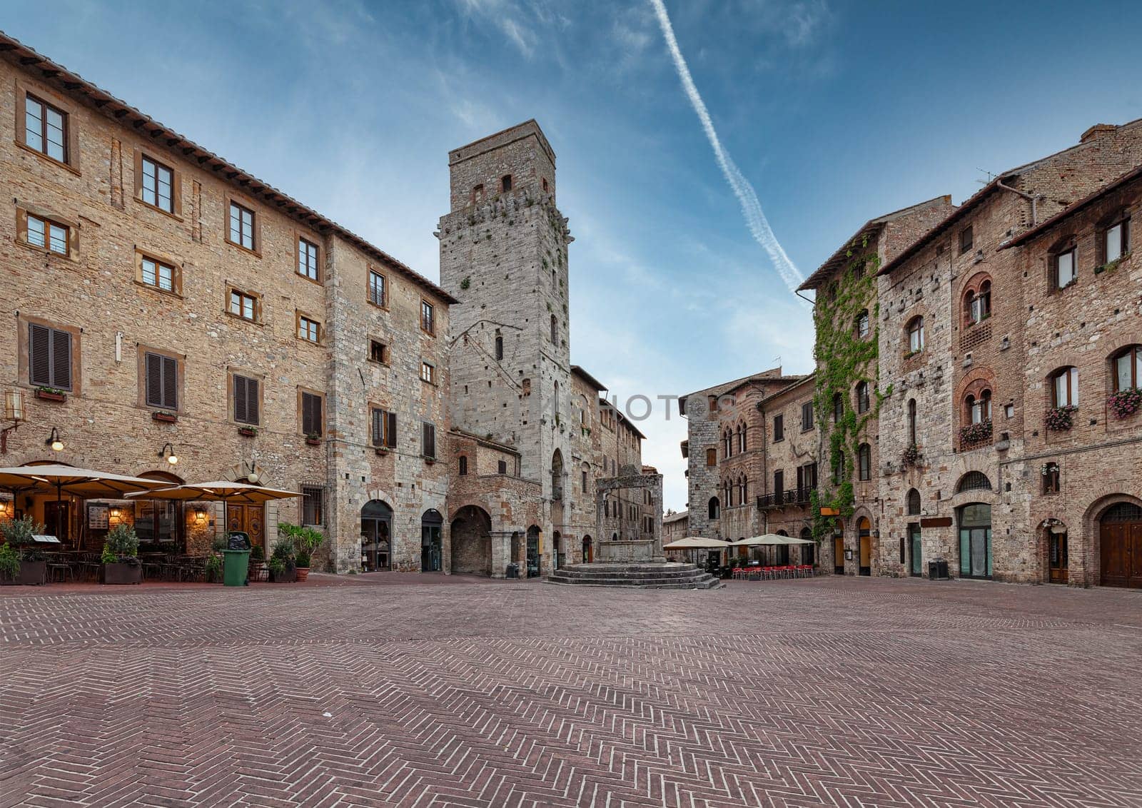 Panoramic view of famous Piazza della Cisterna in the historic town of San Gimignano on a morning, Tuscany, Italy.