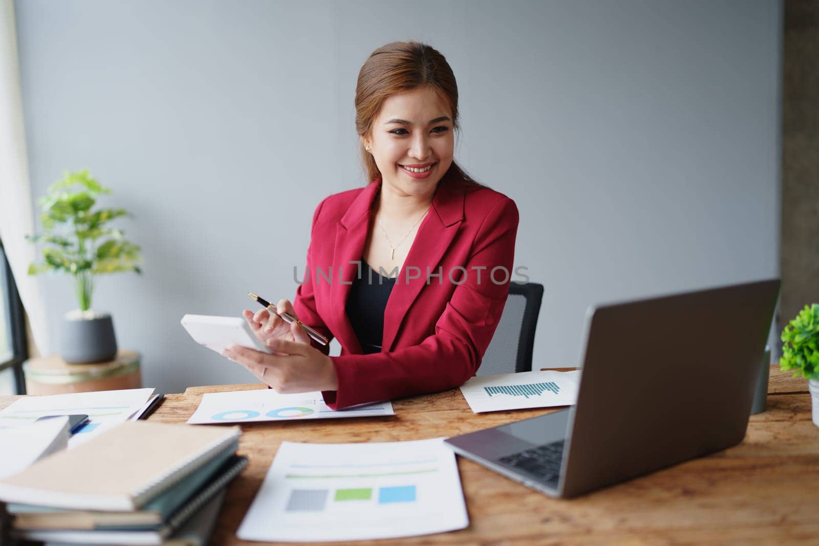 Young asian female work with financial papers at home count on calculator before paying taxes receipts online, planning budget glad to find chance for economy saving money, audit concepts.