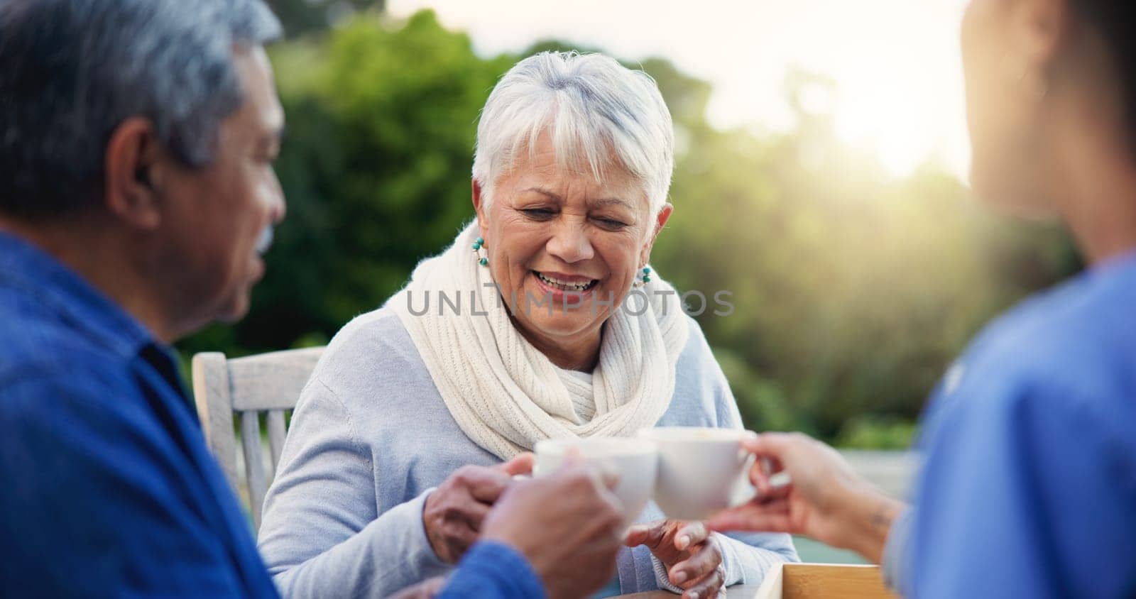 Nurse, tea or toast people in elderly care, retirement or healthcare support at park or nature. Caregiver, senior man or old woman with coffee, meal or outdoor snack together in health and wellness by YuriArcurs