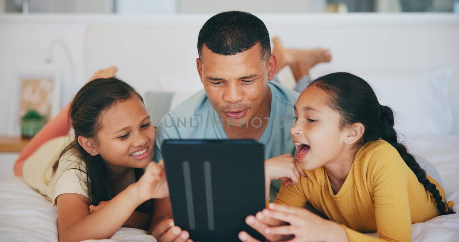 Happy, tablet and children networking with father in living room and relaxing together at home. Digital technology, bonding and girl kids watching video with young dad in the lounge of modern house. by YuriArcurs