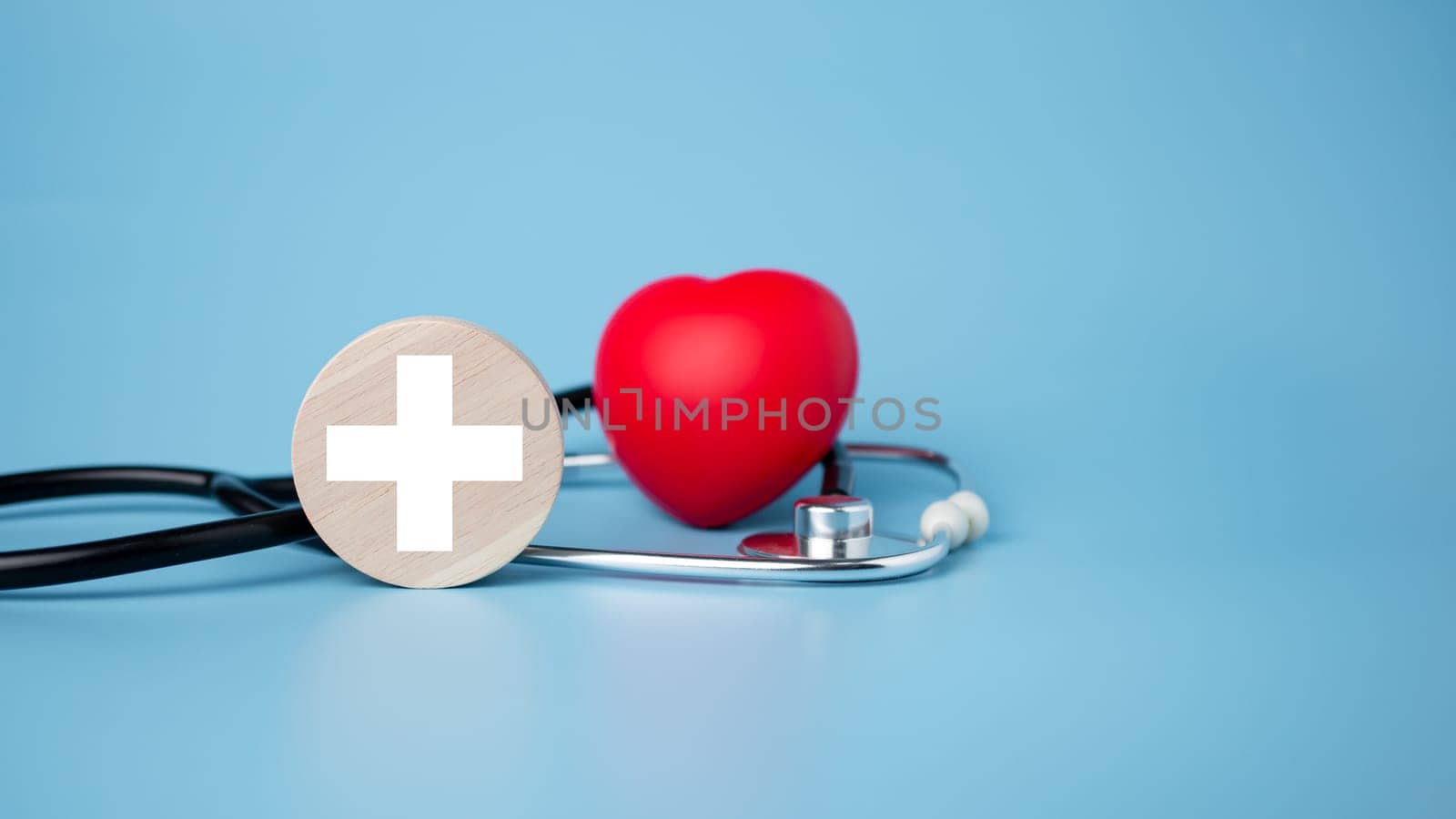 The concept of health insurance and medical welfare. Circle wood and red heart with icon. Health insurance and access to health care. 